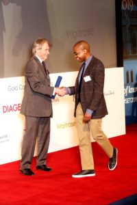 British wine expert, Steven Spurrier, who organized the Judgement of Paris 1976 winetasting, awards Reggie Solomon a DipWSET diploma in Guild Hall in London.